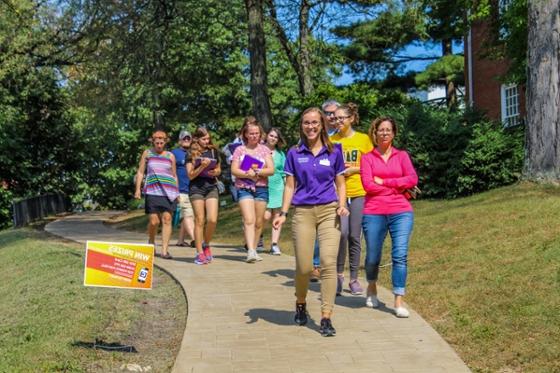 Photo of a Chatham University student giving a tour to a group of people on Shadyside Campus