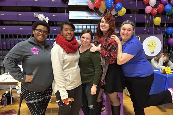 Photo of a group of Chatham students posing at an event, with balloons in the background